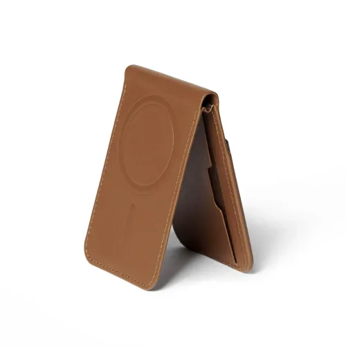 Tan leather wallet stand with MagSafe embossed circle, folds to a vertical A-shape, visible card pocket and stitched edges, slightly angled