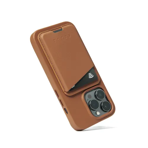 Dark brown leather card case attached to the back of the iPhone, visible card, cutout for triple camera, side buttons and port.
